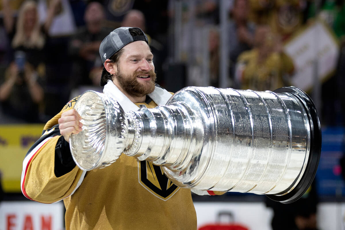 Golden Knights goaltender Adin Hill holds up the Stanley Cup after his team won Game 5 of the N ...