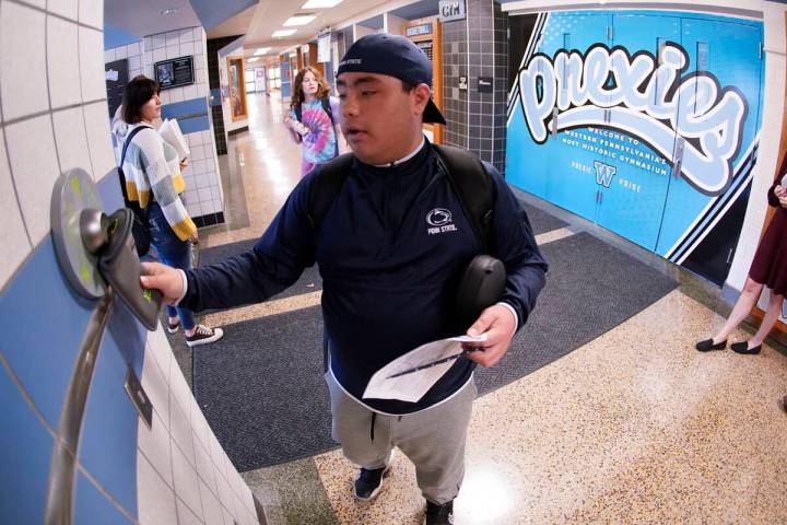 Anthony Bruno, a student at the Washington Junior High School, uses the unlocking mechanism as ...