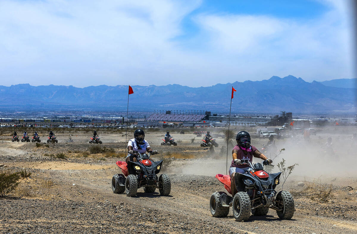 ATV riders take a ride within the Nellis Dunes as hot weather moving into the valley on Saturda ...