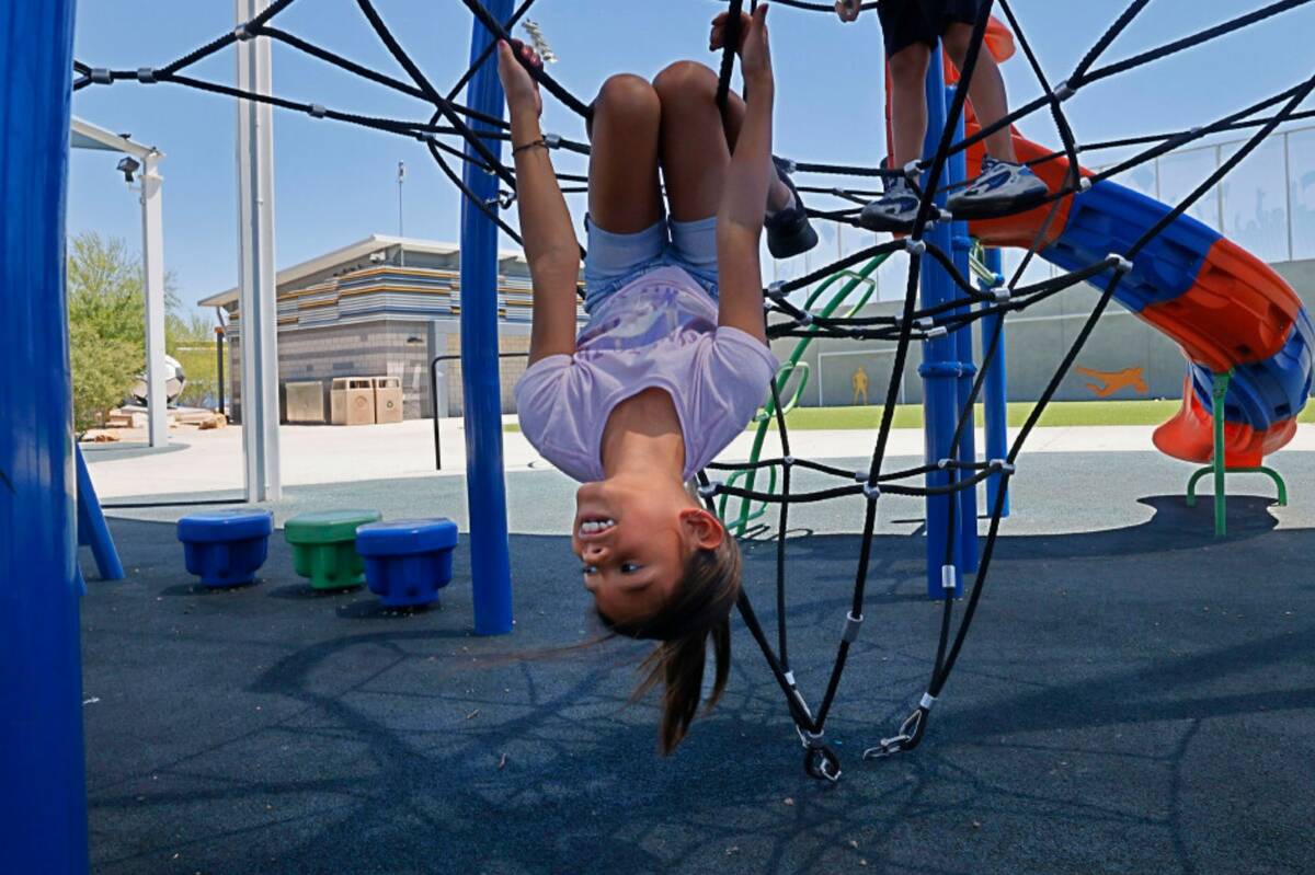 Aliayh Sotelo, 8, of Las Vegas, plays with her brothers and her sisters at Baker Park, Monday, ...