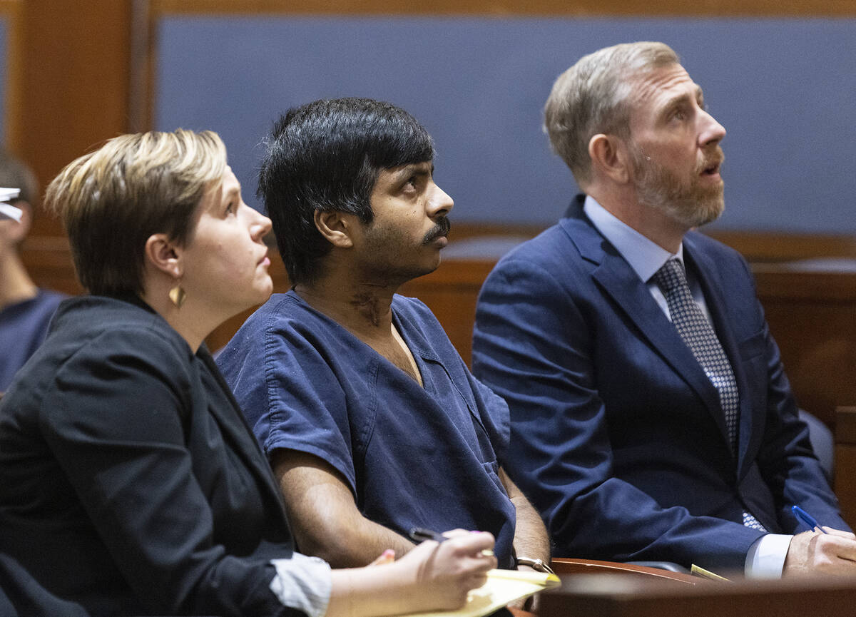 Shiva Gummi, center, and his attorneys Katherine Currie-Diamond, left, and David Westbrook watc ...