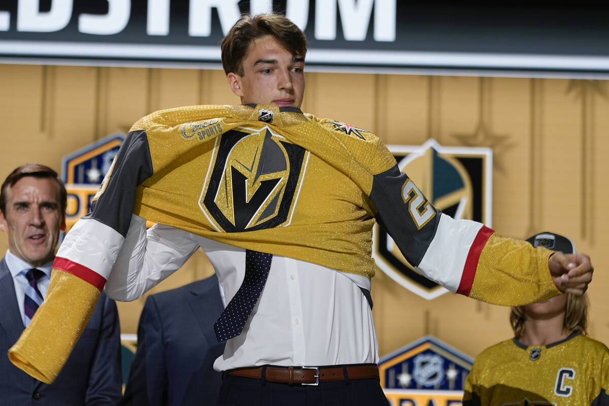 David Edstrom puts on a Las Vegas Golden Knights jersey after being picked by the team during t ...