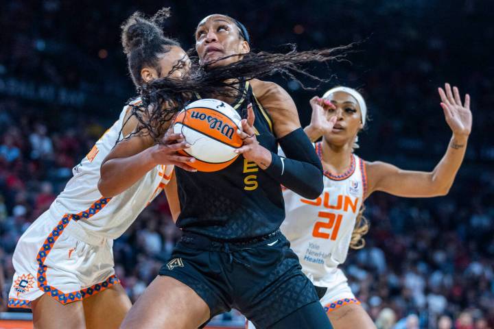 Connecticut Sun forward DeWanna Bonner (24) attempts to stop Las Vegas Aces forward A'ja Wilson ...