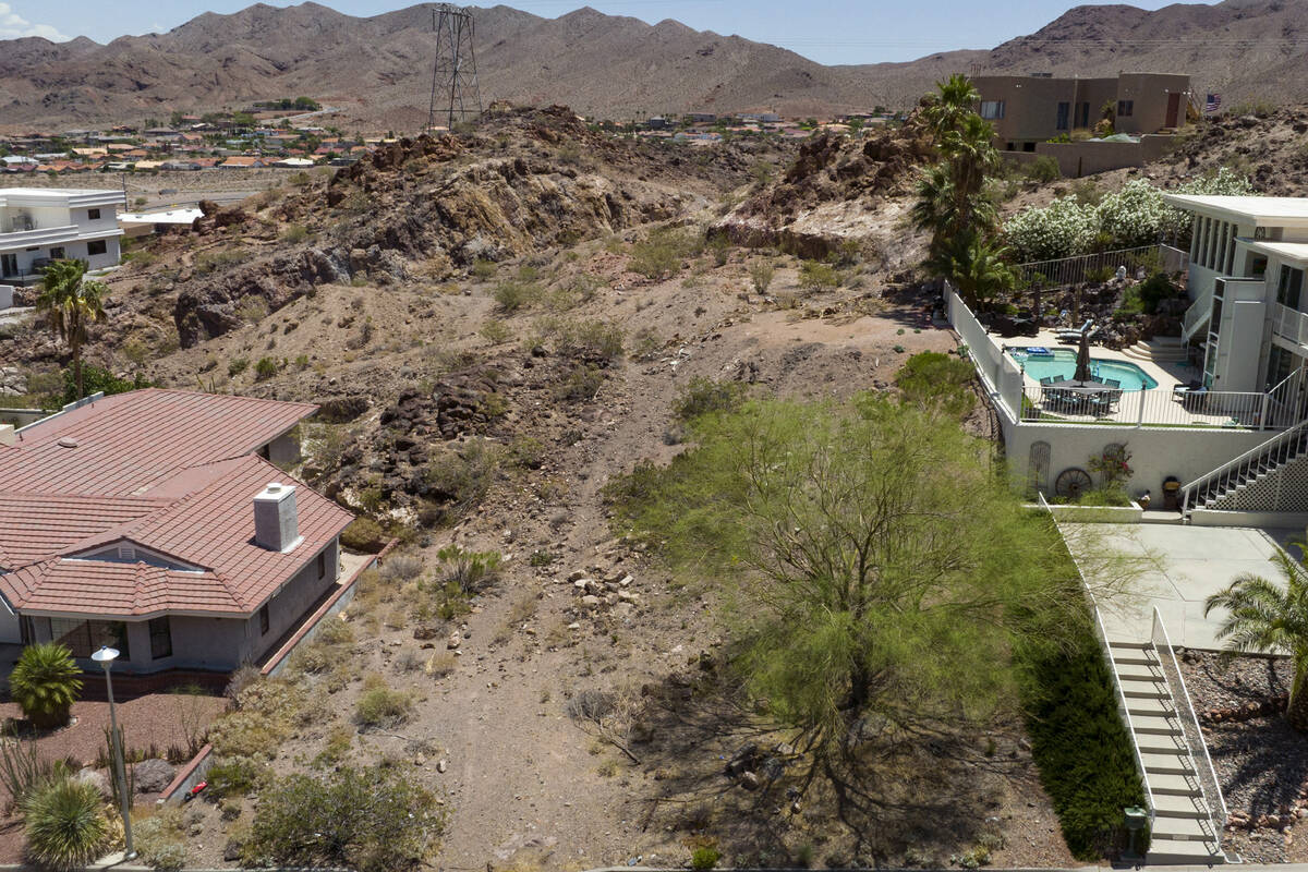 A vacant homesite, center, is seen at the corner of Judi Place and Isabel Drive, on Friday, Jun ...