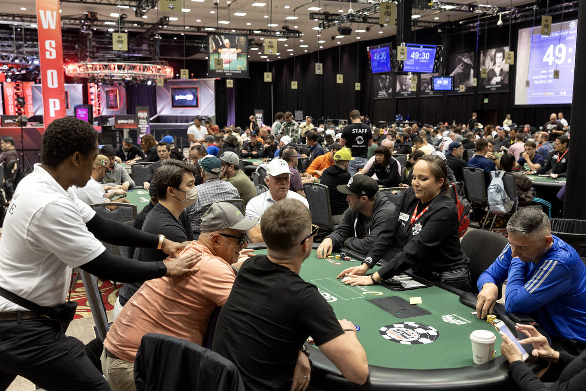 A dealer readies the deck while a player gets a massage during the World Series of Poker $10,00 ...