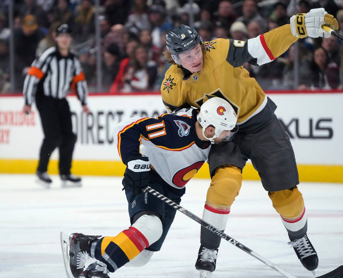 Colorado Avalanche center Andrew Cogliano, front, runs into Vegas Golden Knights defenseman Kae ...