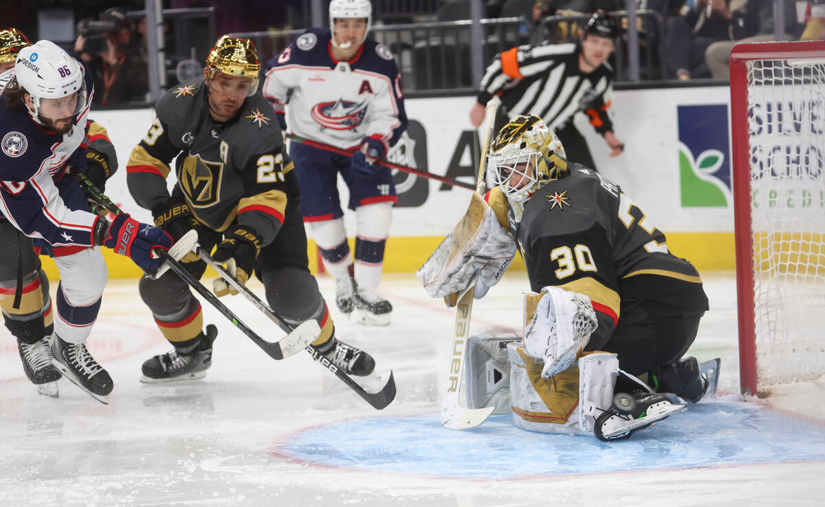 Columbus Blue Jackets right wing Kirill Marchenko (86) sends the puck past Golden Knights defen ...