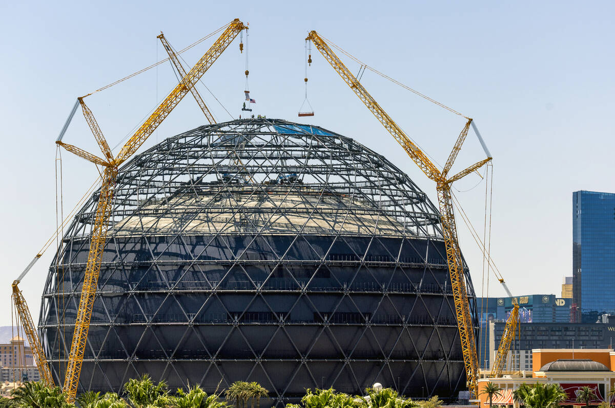 Construction crews bring up to place the last piece of steel beam atop the MSG Sphere at The Ve ...