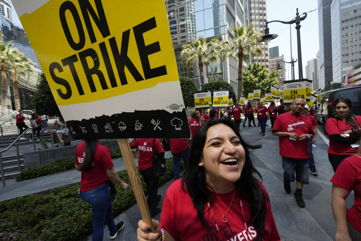 Striking hotel workers rally outside the Intercontinental Hotel after walking off their job ear ...