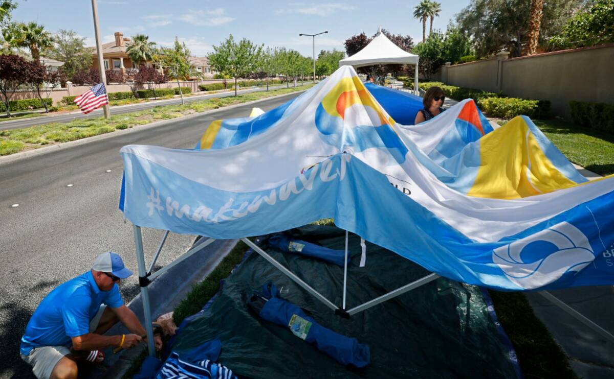 Andrew Danzeisen of Summerlin sets up a tent with his wife Melanie, Monday, July 3, 2023, along ...