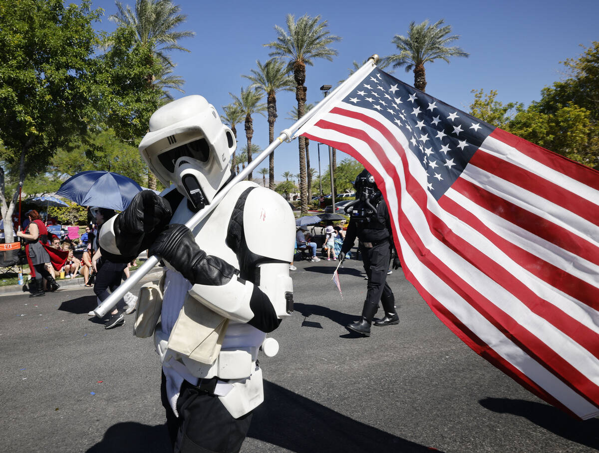 A performer dressed as stormtrooper from "Star Wars" carries an American flag during ...