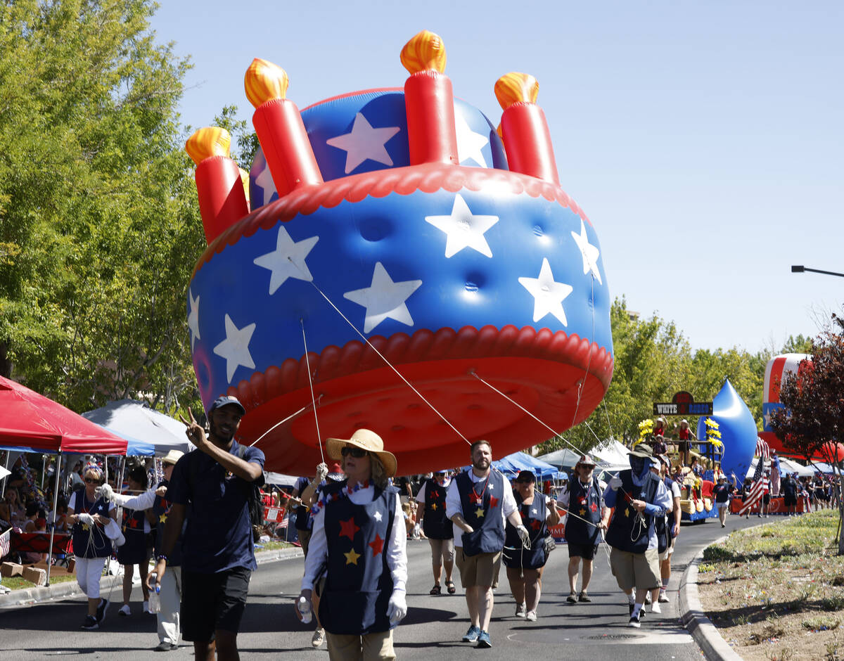 People carry a large inflatable balloon during the annual Summerlin Council Patriotic Parade, T ...
