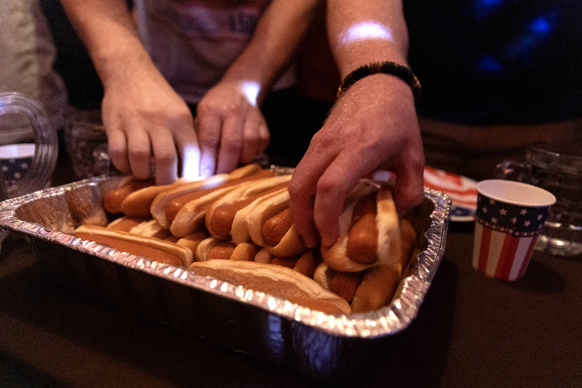 Competitors begin to feast during the third annual Fourth of July hot dog eating contest at The ...