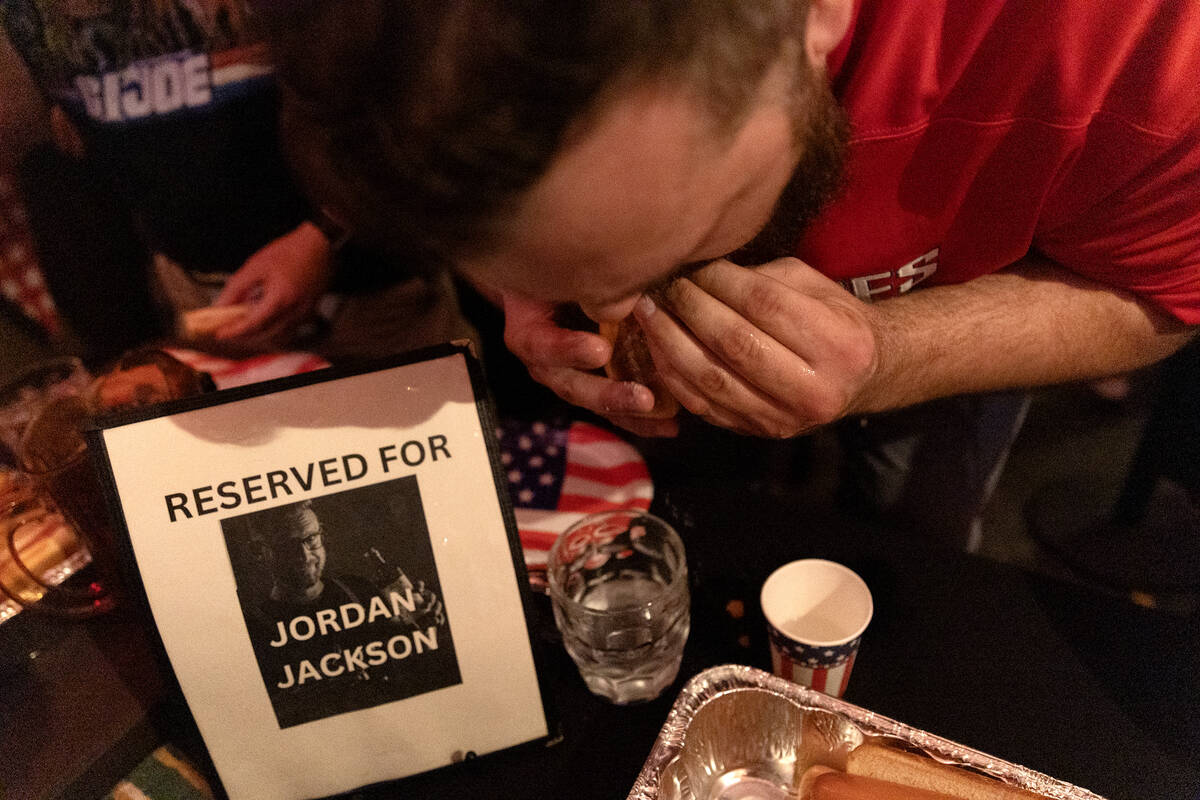 Champion Jordan Jackson eats a hot dog doused in water during the third annual Fourth of July h ...