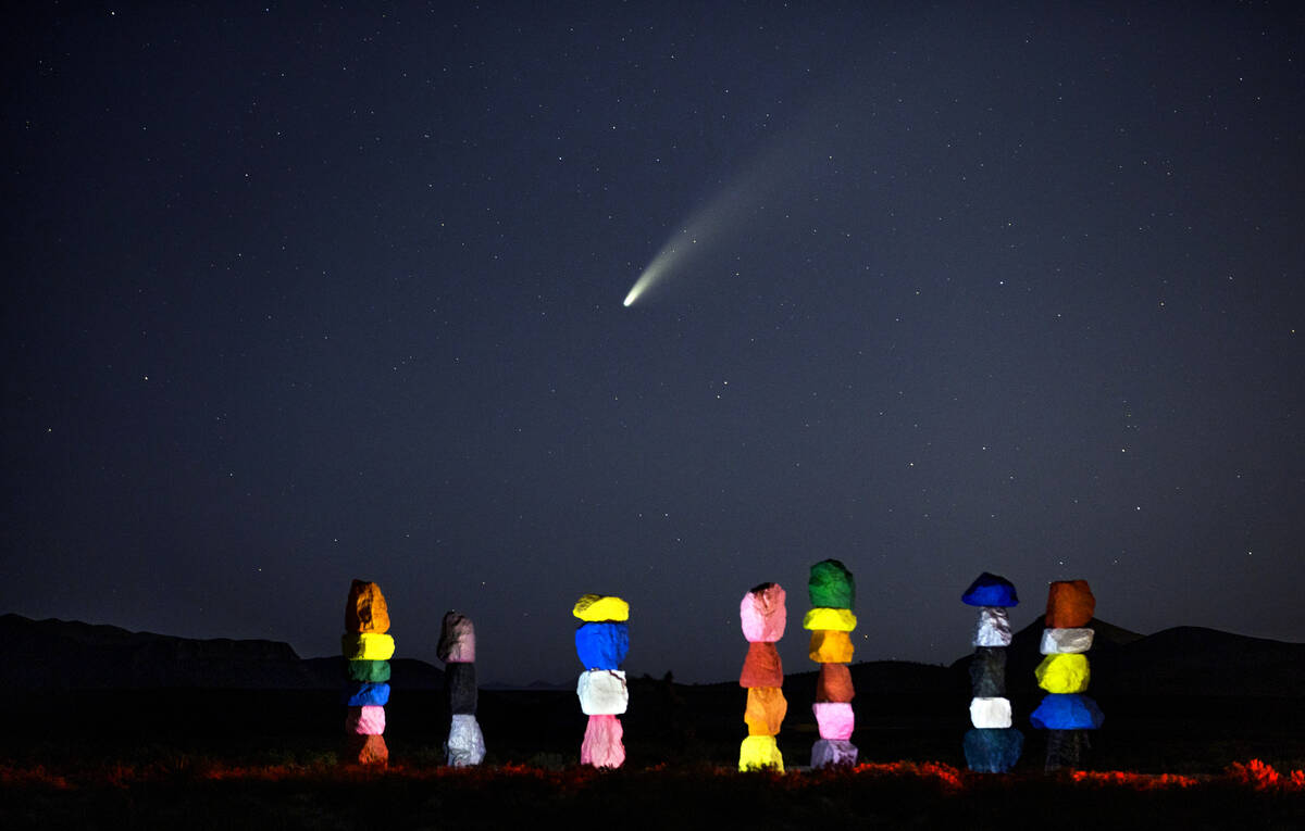 Comet NEOWISE streaks across the sky above the Seven Magic Mountains art installation on July 1 ...