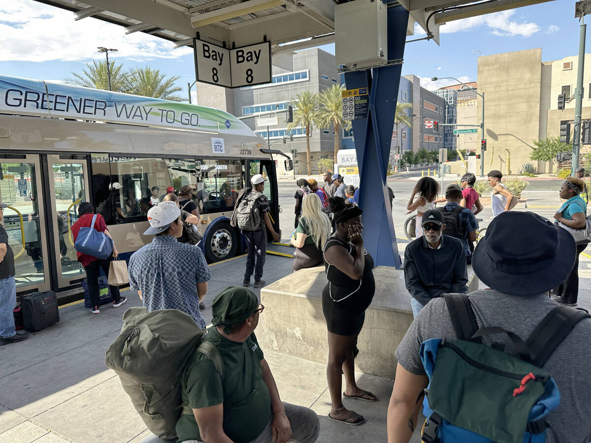 Bus riders prepare to board a Regional Transportation Commission bus at the Bonneville Transit ...