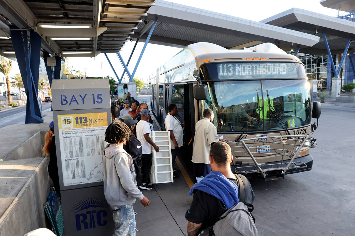 Passengers board a bus at the Regional Transportation Commission Bonneville Transit Center in d ...