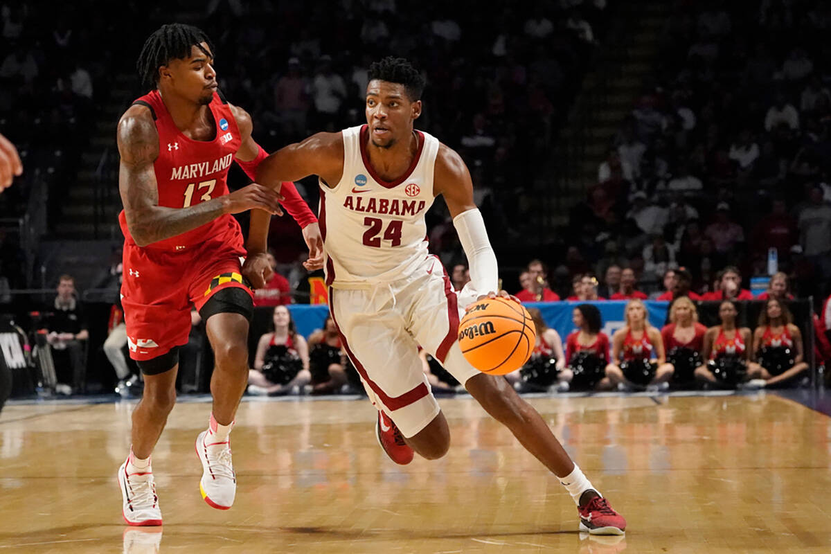 Alabama forward Brandon Miller (24) dribbles past Maryland guard Hakim Hart (13) in the second ...