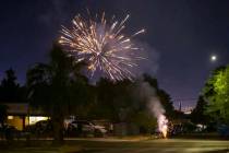 Illegal fireworks go off in a neighborhood near downtown Las Vegas in July 2021. (Chase Stevens ...