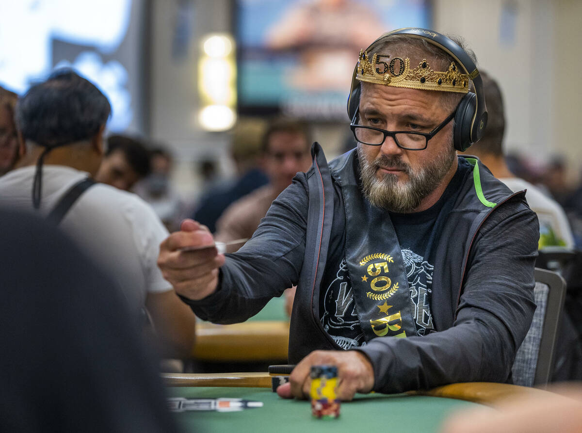 A player sports a crown during the final starting flight of World Series of Poker $10,000 buy-i ...