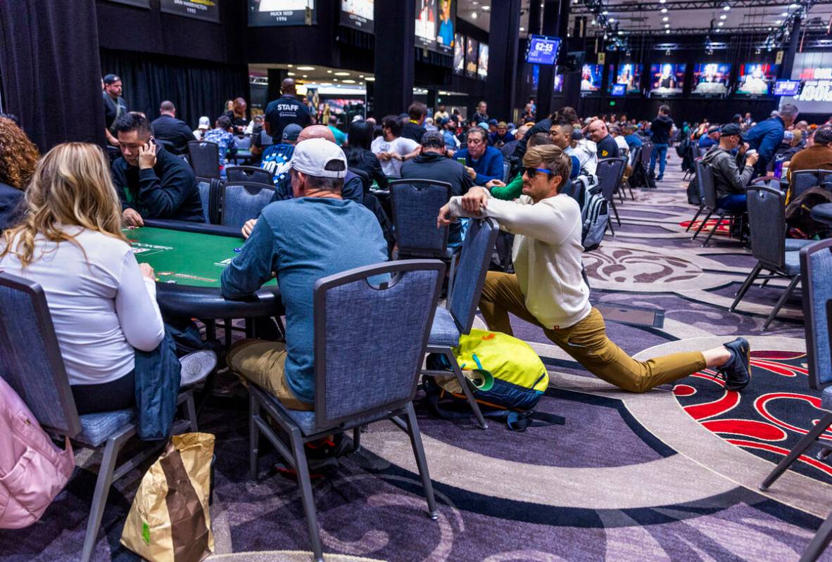 A player stretches out as plays continues during the final starting flight of World Series of P ...