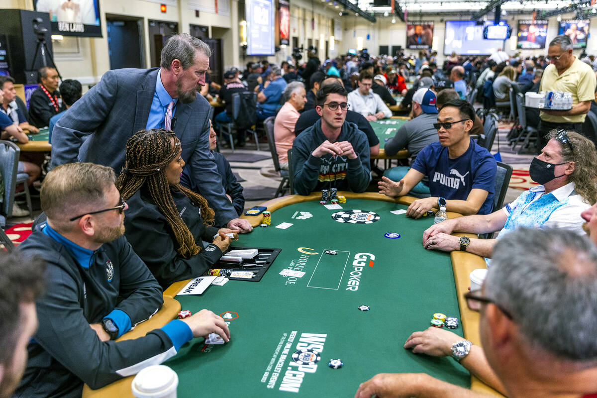 An official sorts out an issue on a table during the final starting flight of World Series of P ...