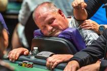 A player takes a quick nap as he is massaged during the final starting flight of World Series o ...