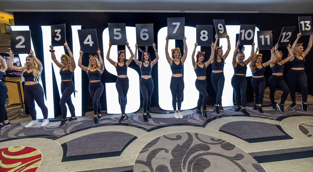 Models enter and hold numbers representing Phil Hellmuth's 17 gold bracelets as the “The ...