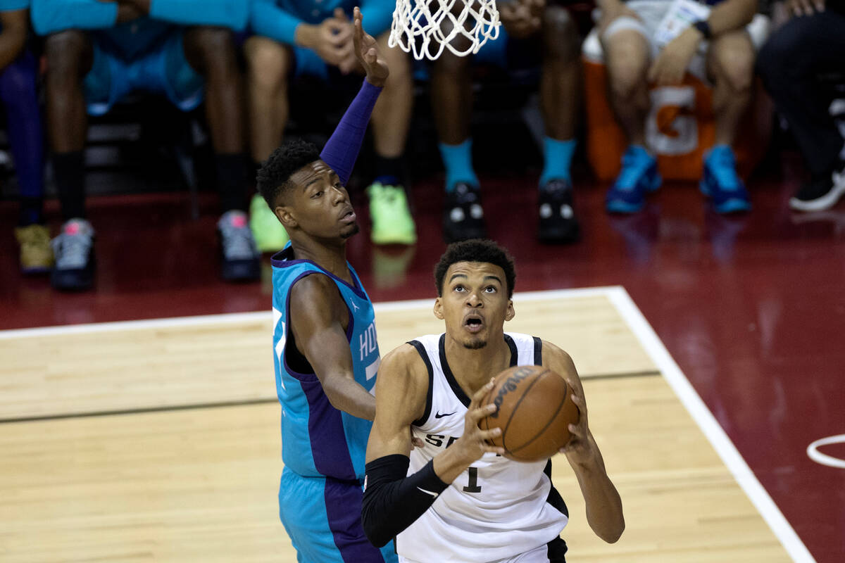 San Antonio Spurs forward Victor Wembanyama (1) shoots against Charlotte Hornets forward Brando ...