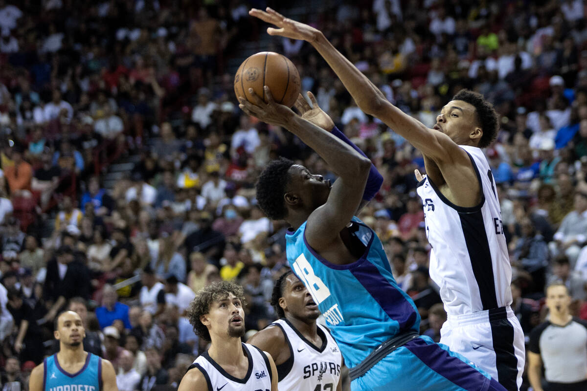 San Antonio Spurs forward Victor Wembanyama (1) blocks a shot by Charlotte Hornets forward Tre ...