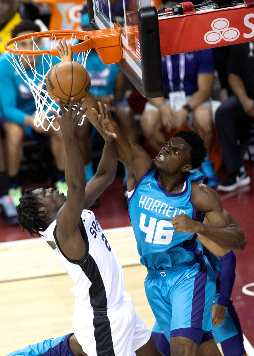 San Antonio Spurs center Charles Bediako (27) shoots against Charlotte Hornets center James Nna ...