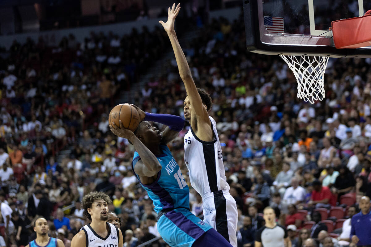 Charlotte Hornets forward Tre Scott (18) shoots against San Antonio Spurs forward Victor Wemban ...