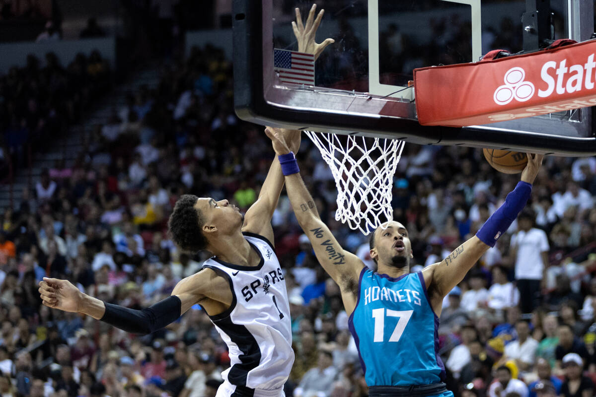 Charlotte Hornets guard Amari Bailey (17) shoots against San Antonio Spurs forward Victor Wemba ...