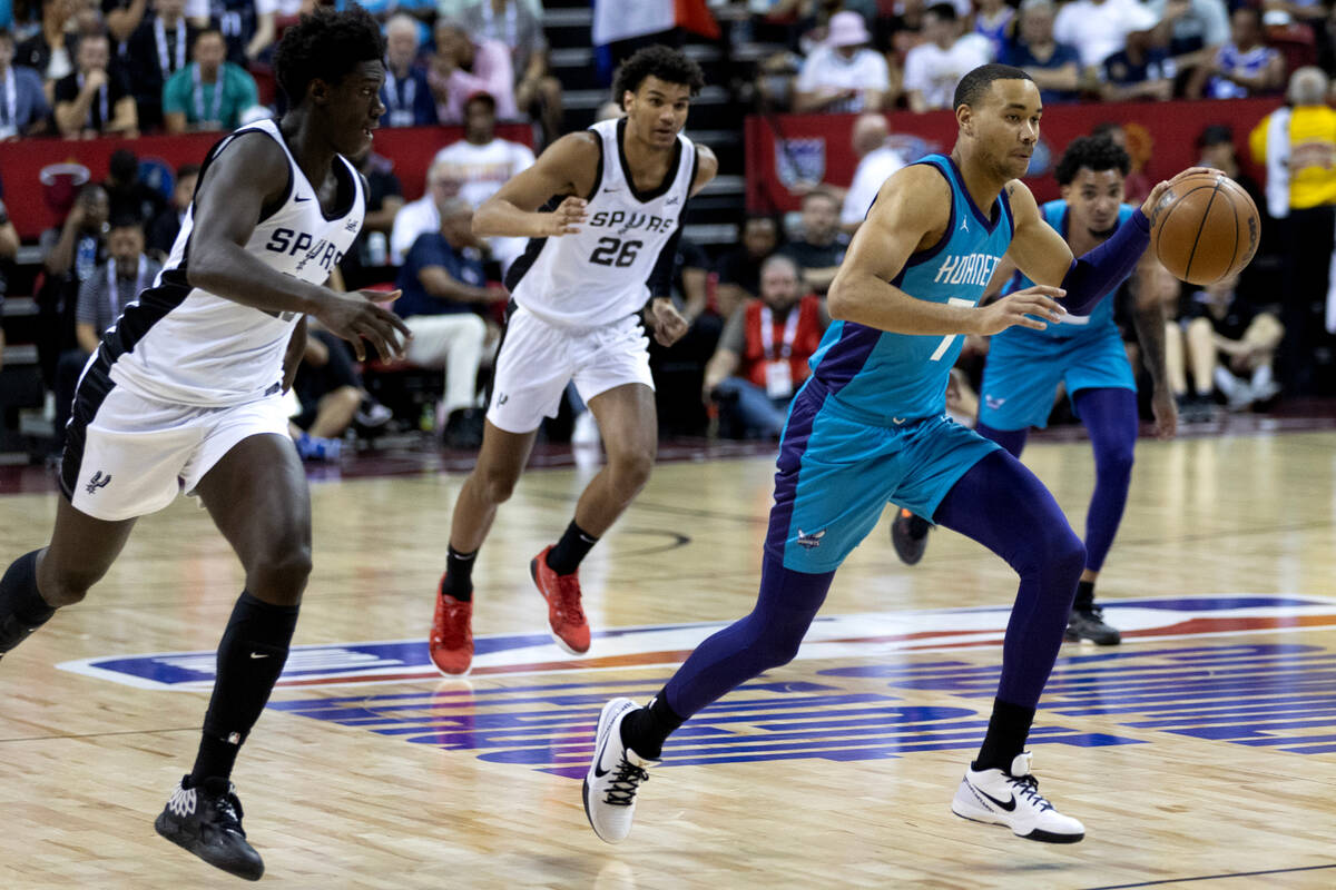 Charlotte Hornets guard/forward Bryce McGowens (7) dribbles up the court followed by San Antoni ...