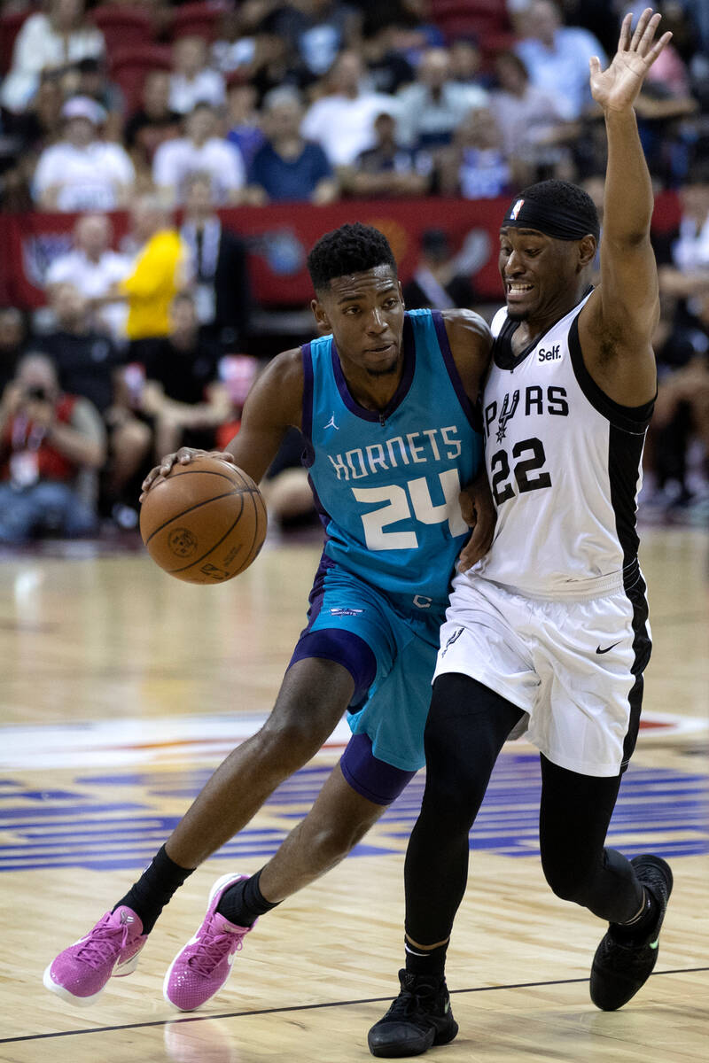 Charlotte Hornets forward Brandon Miller (24) dribbles around San Antonio Spurs guard Malaki Br ...