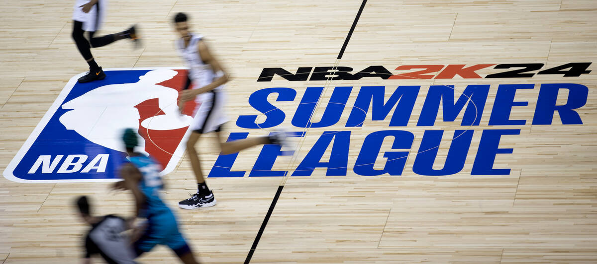 San Antonio Spurs forward Victor Wembanyama, center left, runs up the court during an NBA Summe ...