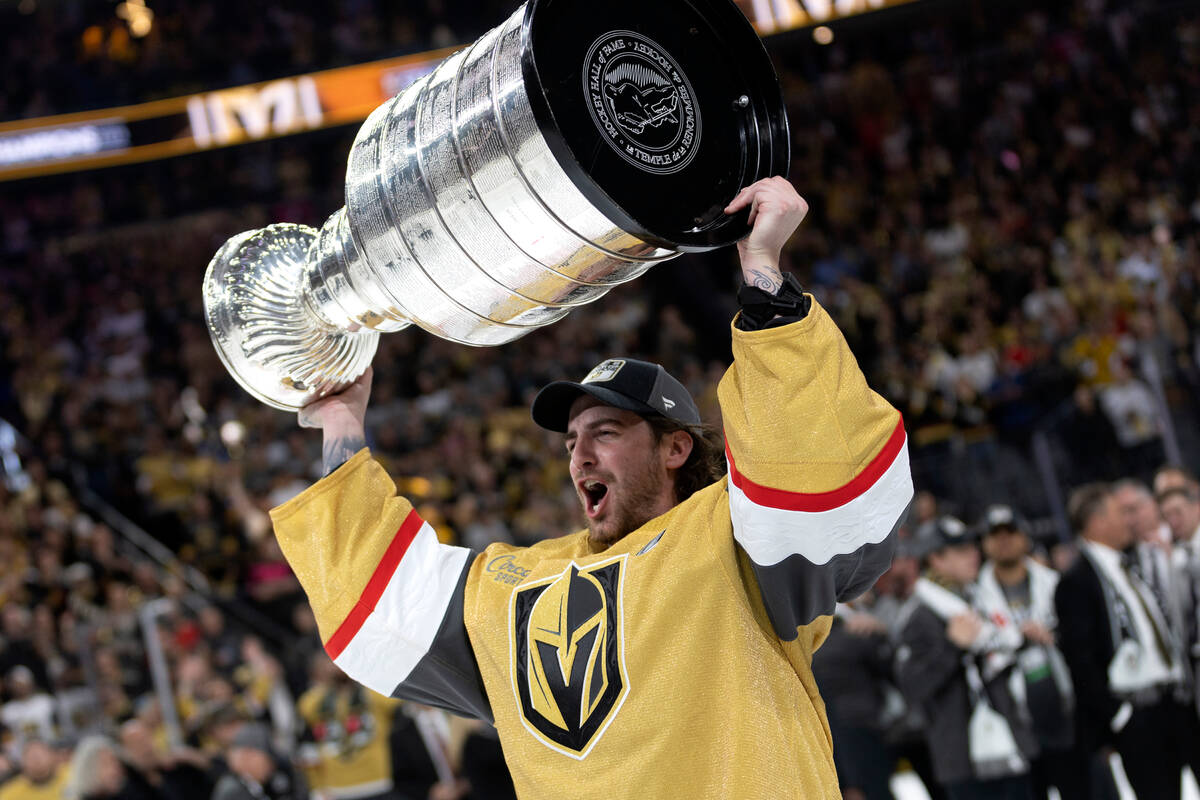 Golden Knights goaltender Laurent Brossoit (39) celebrates with the Stanley Cup after winning t ...