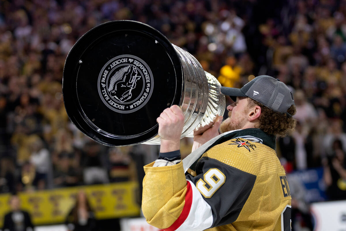 Golden Knights center Jack Eichel (9) hoists with the Stanley Cup after winning the NHL hockey ...