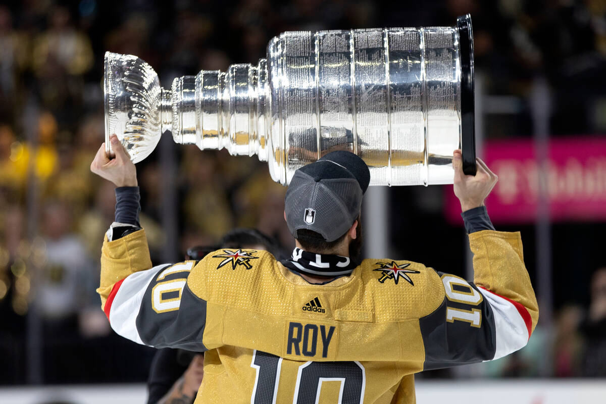 Golden Knights center Nicolas Roy (10) celebrates with the Stanley Cup after winning the NHL ho ...