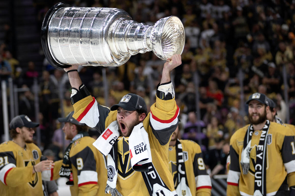 Golden Knights center Paul Cotter (43) celebrates with the Stanley Cup after winning the NHL ho ...