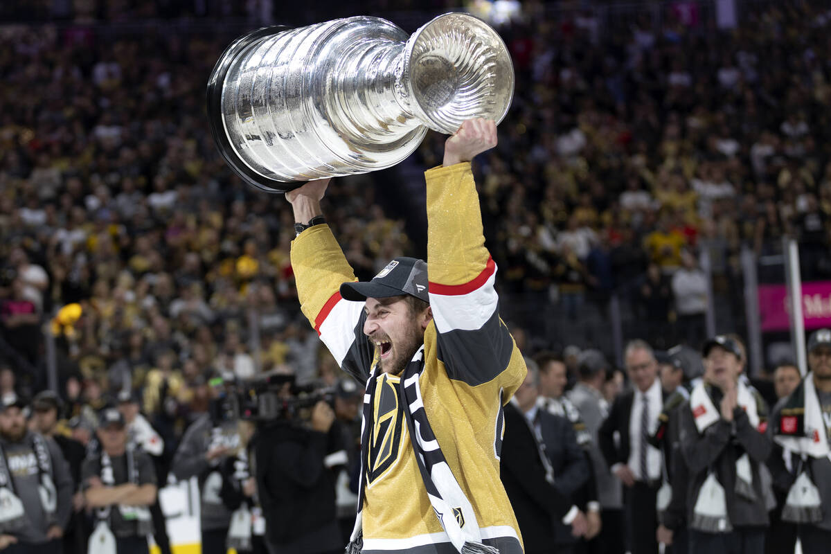 Golden Knights defenseman Brayden Pachal (94) celebrates with the Stanley Cup after winning the ...