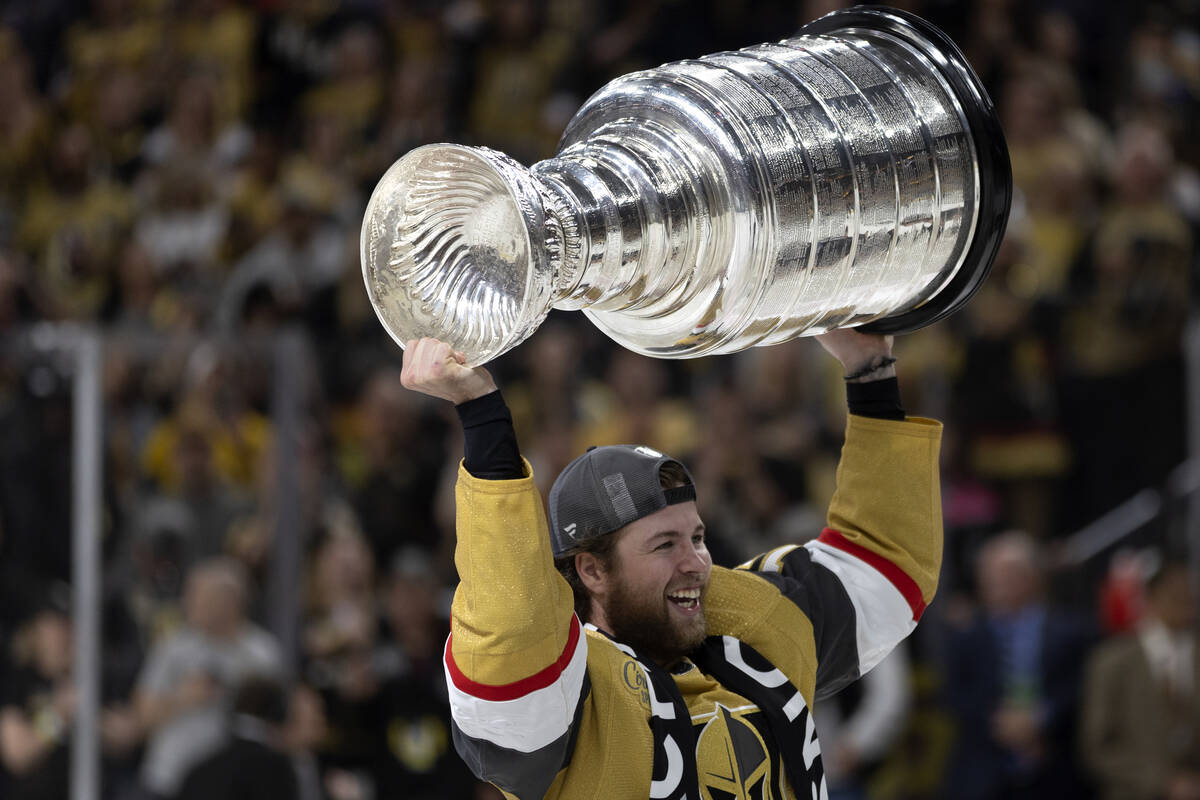 Golden Knights defenseman Ben Hutton (17) celebrates with the Stanley Cup after winning the NHL ...