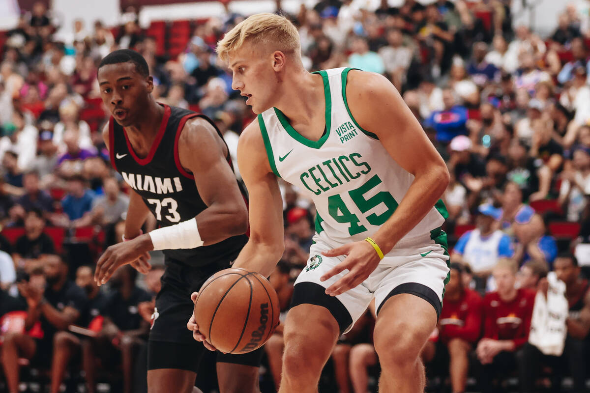 Boston Celtics forward Sam Griesel (45) keeps the ball from Miami Heat guard Chase Audi (73) du ...