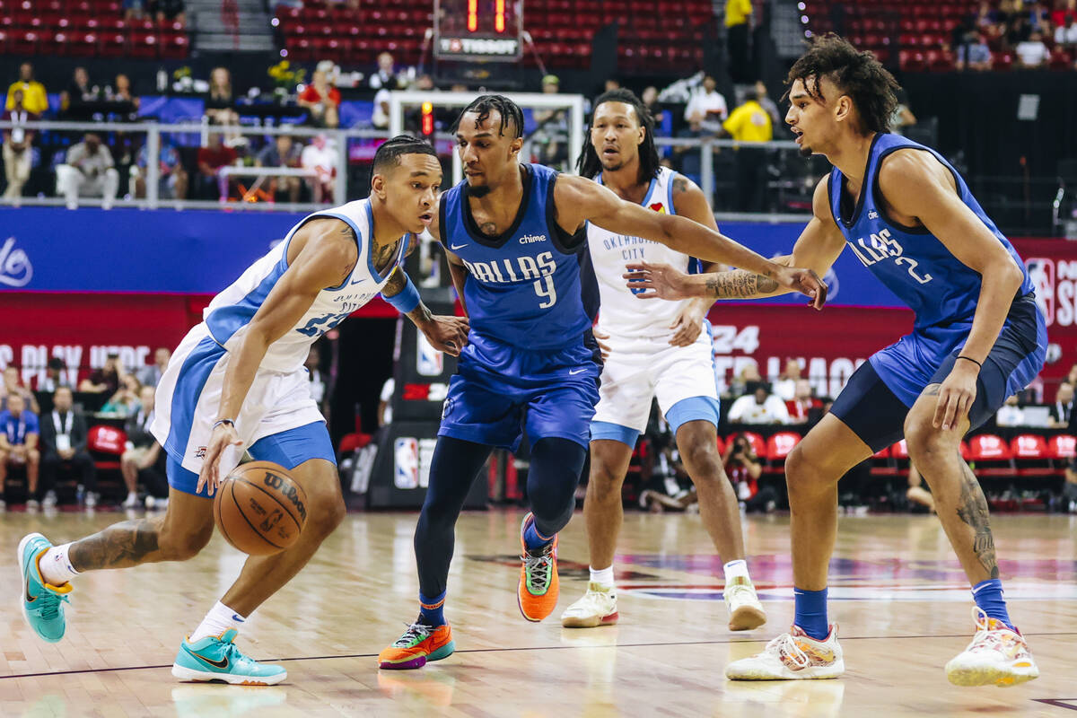 Oklahoma City Thunder guard Tre Mann (23) dribbles the ball past Dallas Mavericks guard A.J. La ...