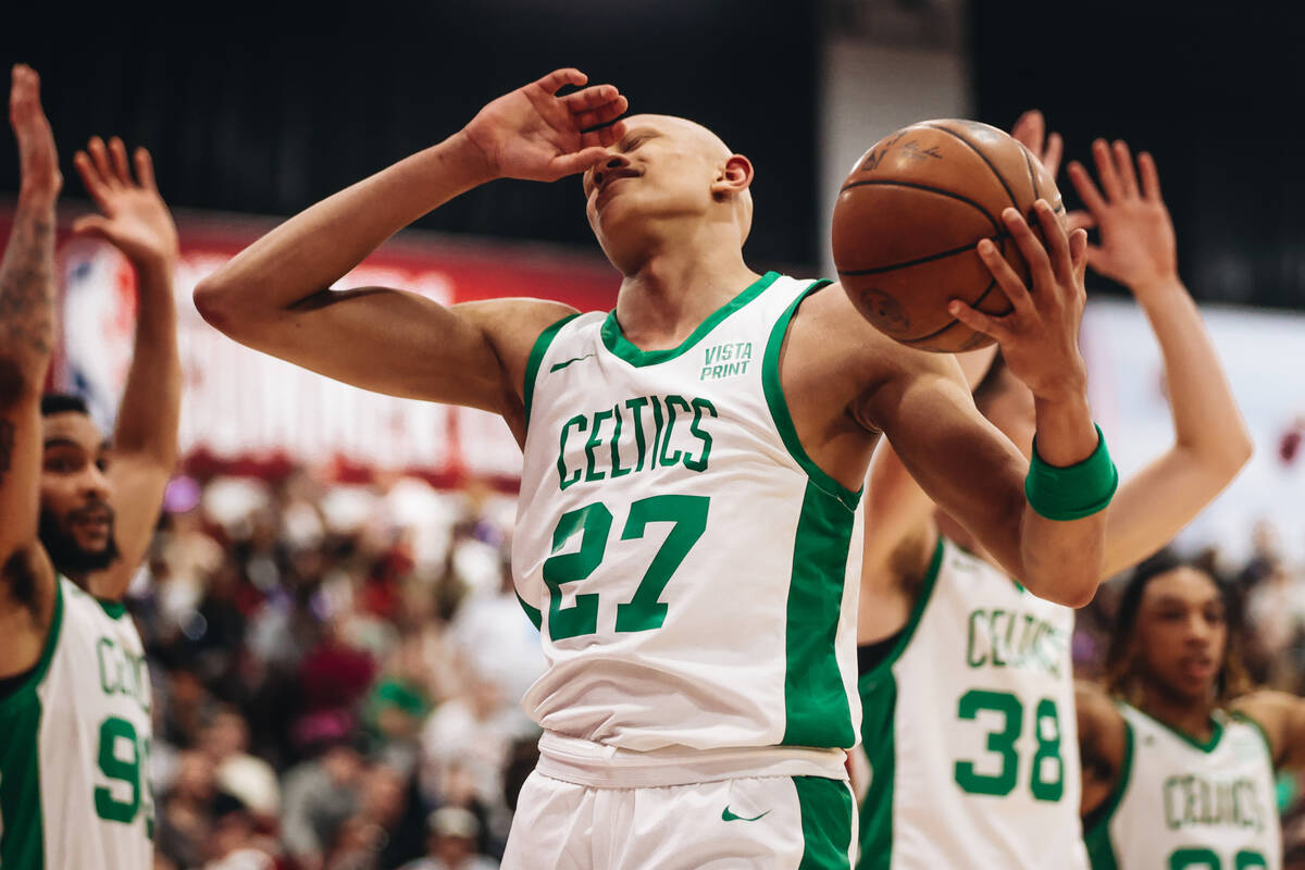 Boston Celtics forward Jordan Walsh reacts as a referee fouls his teammate mid-play during an N ...