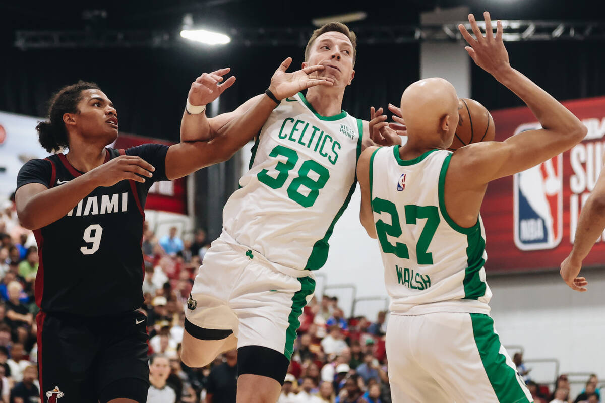 Miami Heat guard Dru Smith (9) swipes the face of Boston Celtics forward Justin Bean (38) durin ...