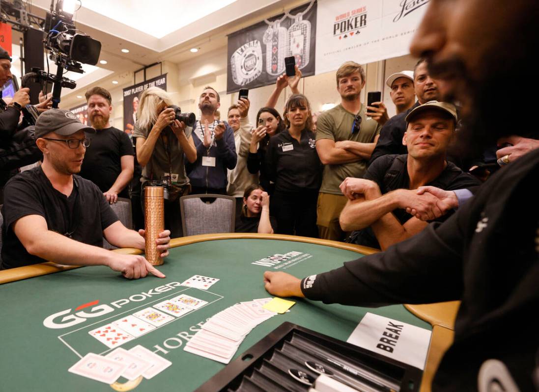 Jeppe Bisgaard of Denmark, right, congratulates after he won a free seat to the Main Event as P ...