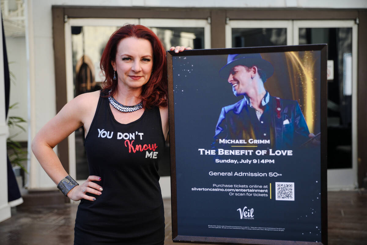 Lucie Grimm, wife of Michael Grimm, poses for a portrait by a sign for the Michael Grimm Benefi ...