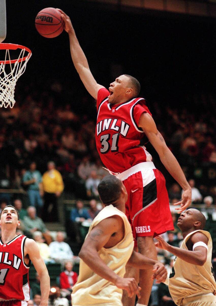 UNLV center Shawn Marion (31) dunks the ball over Colorado State's Andre McKanstry, right, and ...
