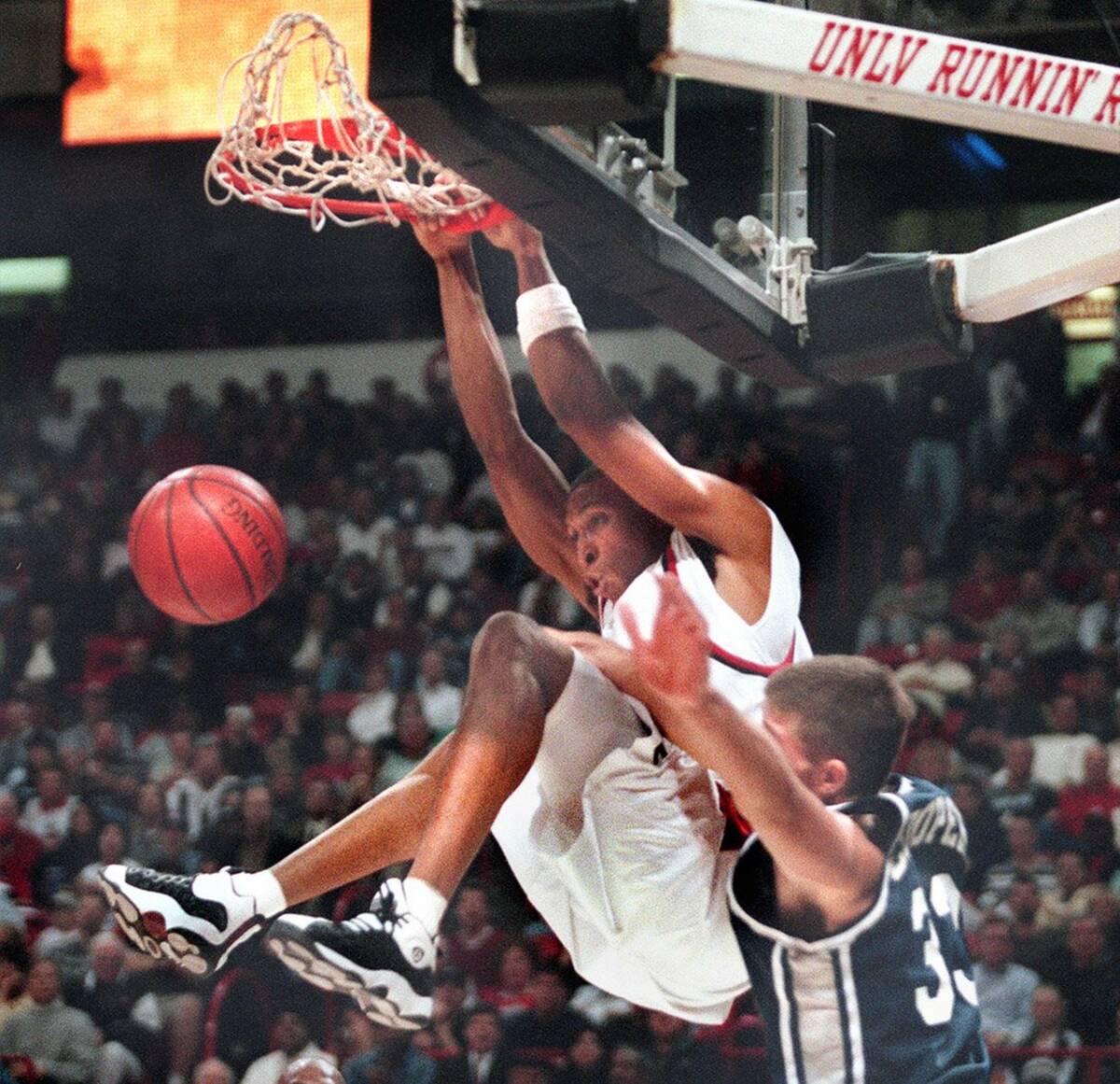 UNLV's Shawn Marion dunks the ball over Erik Cooper of Rice in the first half of Thursday's gam ...